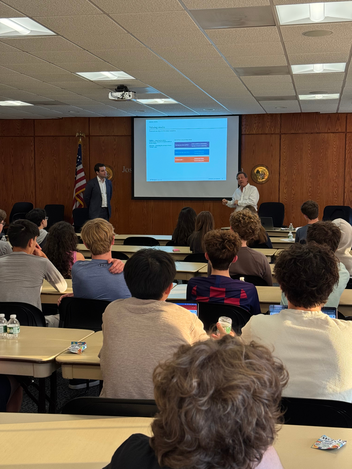 A J.P. Morgan private wealth advisor addressing a room of Greenwich students during the investing segment